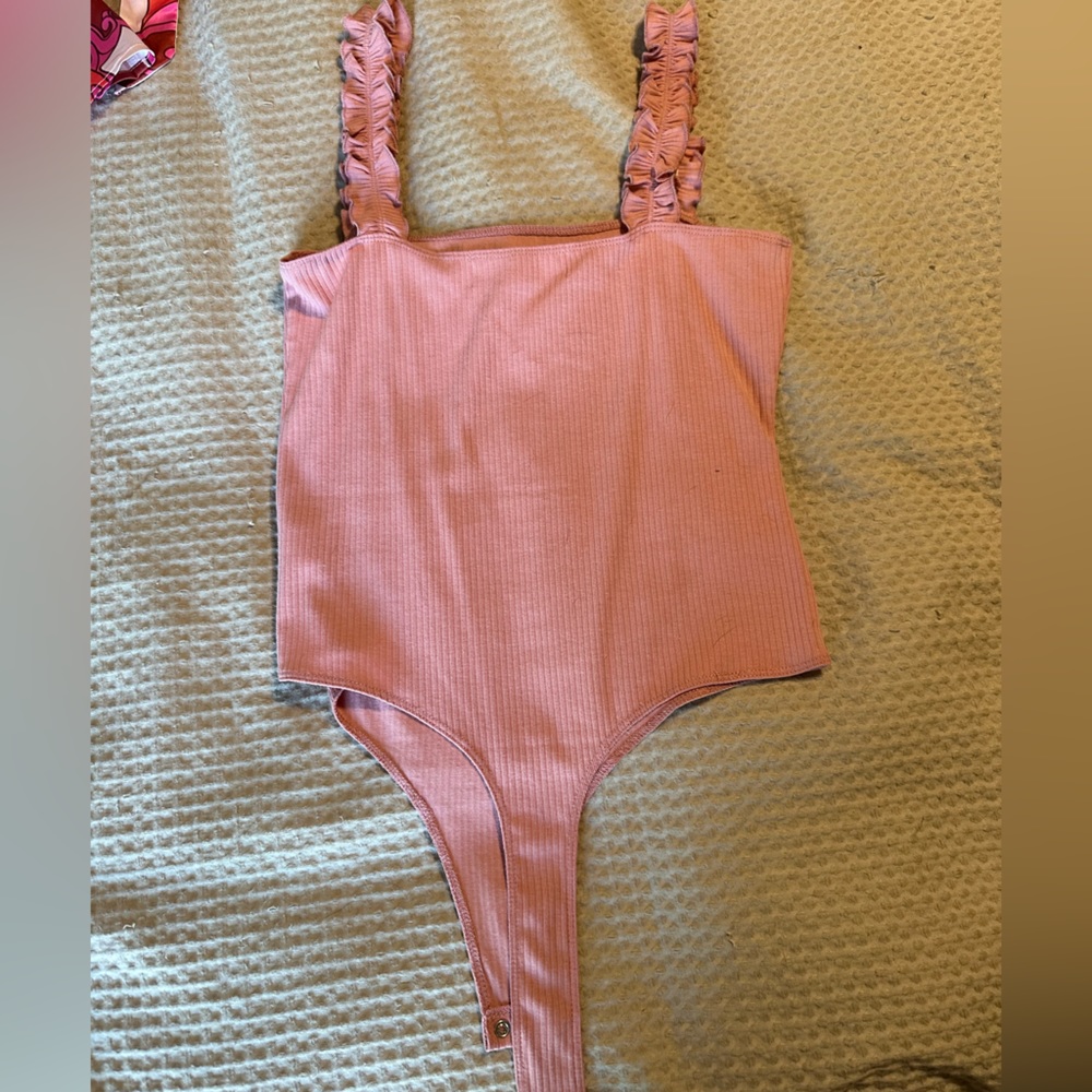 Pink ruffle bodysuit. Never worn!